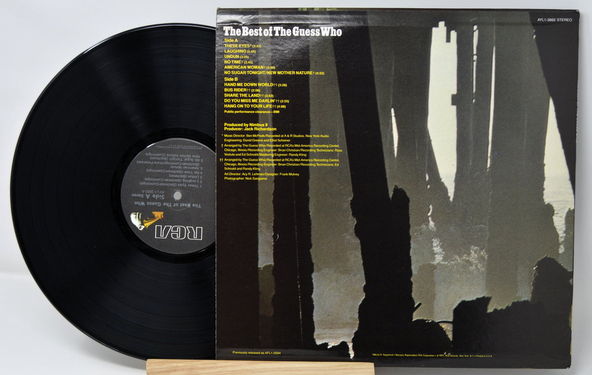 Vinyl record with cover featuring a silhouette design on a white background