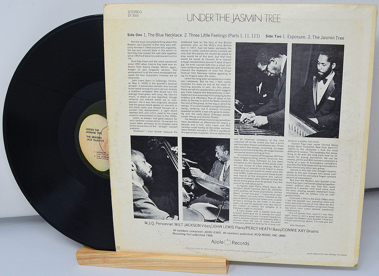 Back cover of 'Under the Jasmin Tree' LP by The Modern Jazz Quartet showing liner notes, band photos, and tracklist