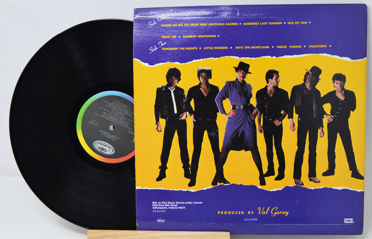 Vinyl record with a colorful cover featuring a group of people on a yellow background