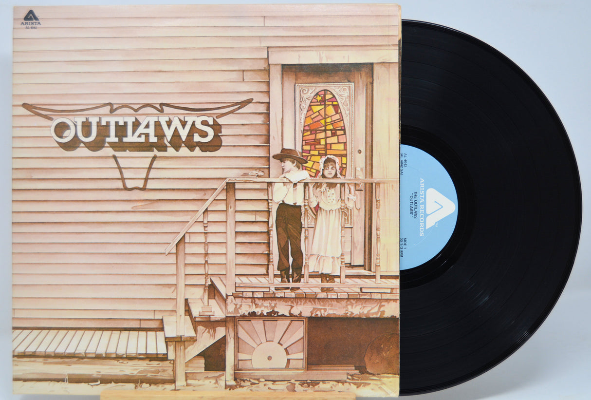 Vinyl record with 'Outlaws' album cover featuring a couple on a porch.