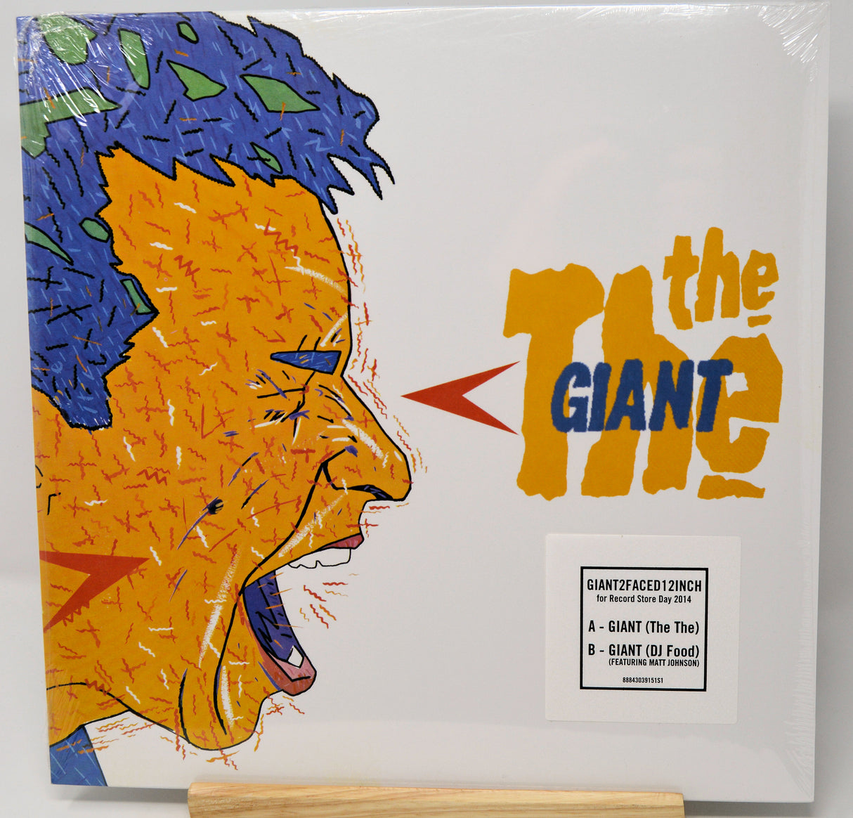 Vinyl record cover with a stylized face and 'The Giant' text on a white background