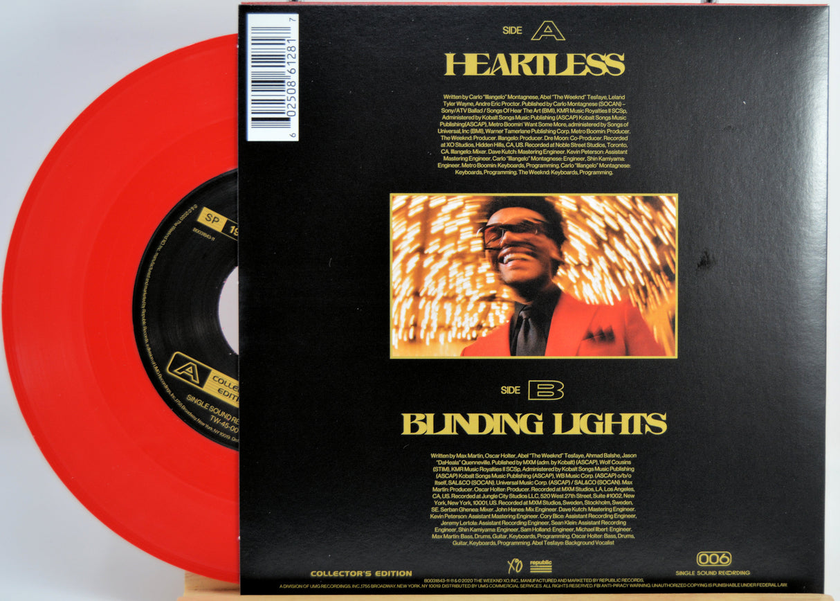 The Weeknd Vinyl record with red disc and black back cover featuring a smiling man and album title 'Blinding Lights'.