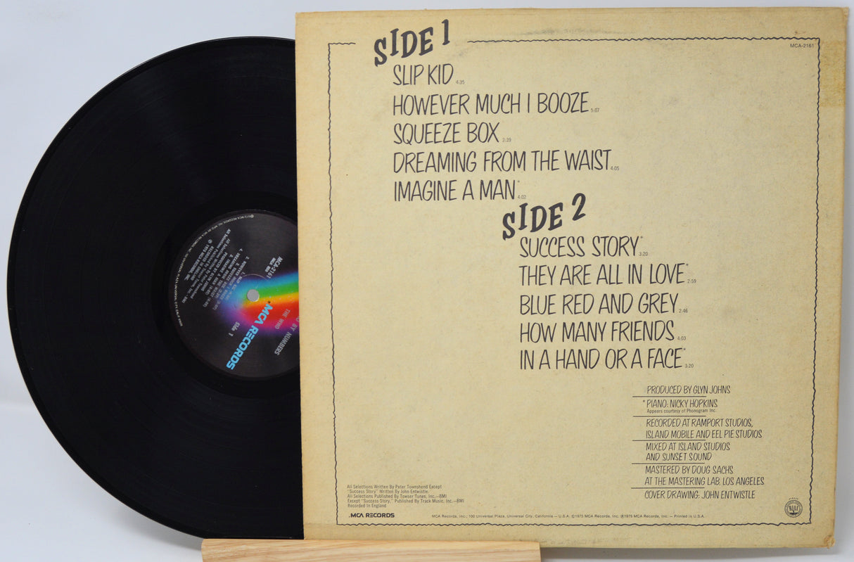 Vinyl record with a brown label on a light gray background