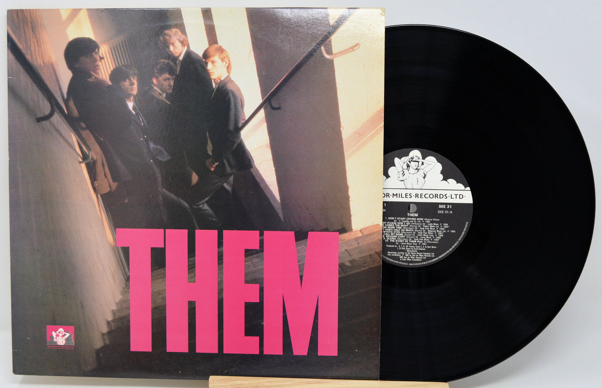 Vinyl record with 'THEM' album cover showing a group of people on stairs.