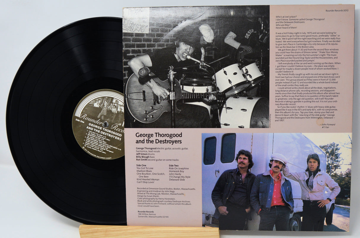 Vinyl record with a gatefold cover featuring black and white photos and text.
