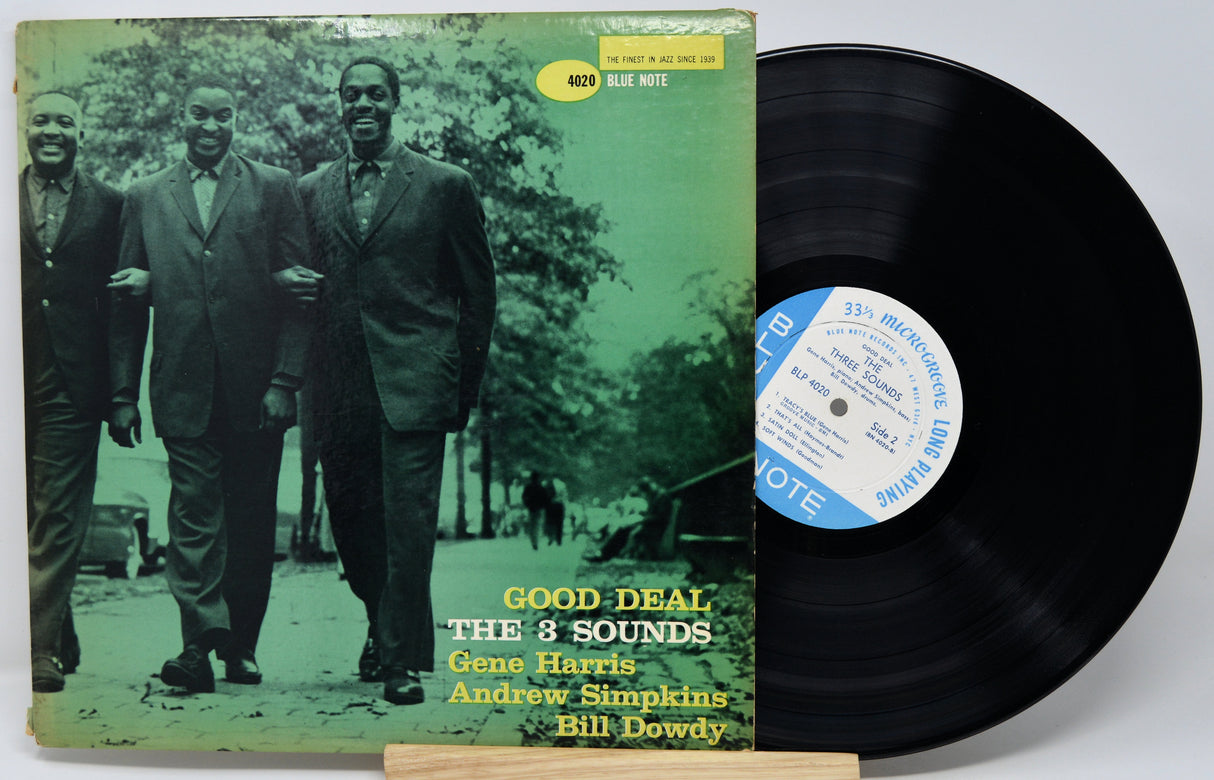 Vinyl record with cover featuring three men and a 'Good Deal' label.