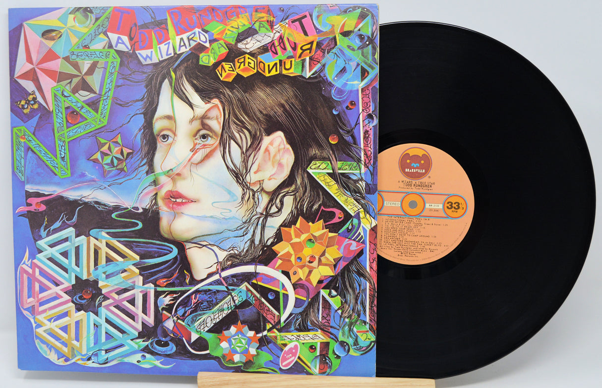 Vinyl record with a colorful cover featuring abstract designs and text.