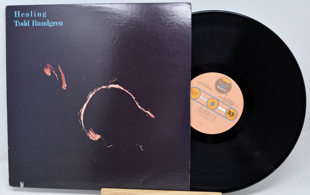 Vinyl record with cover featuring colorful artwork and text