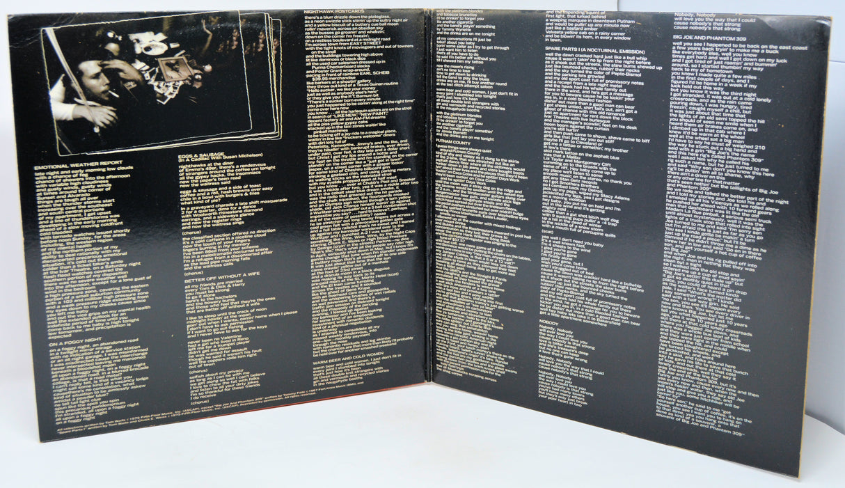 Open book or album with text on a black background
