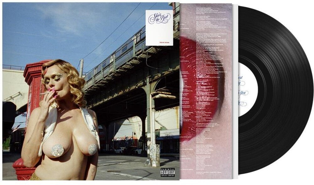 A vinyl record album shown open with the printed cover and track listing visible, alongside a black vinyl disc. The cover art features a woman outdoors under an elevated train track, with a large red abstract shape on the right side of the cover.