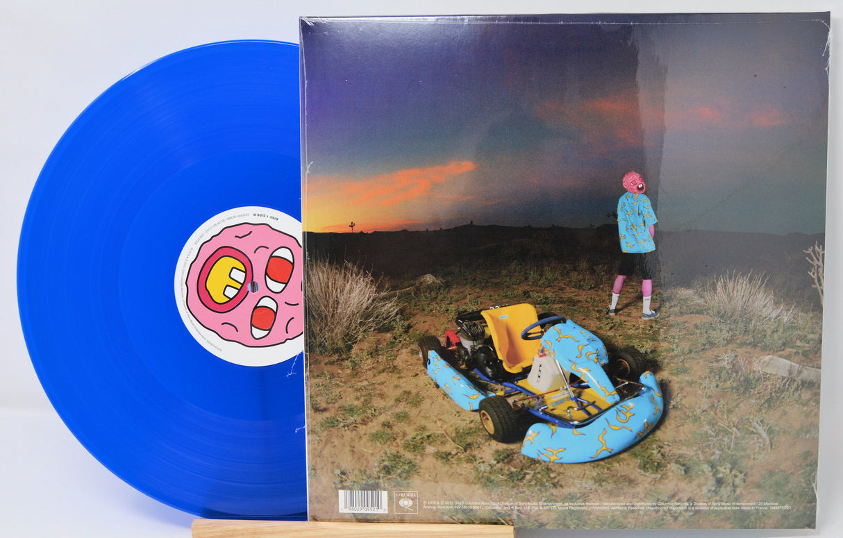 Blue vinyl record with a colorful album cover featuring a desert scene and a person.