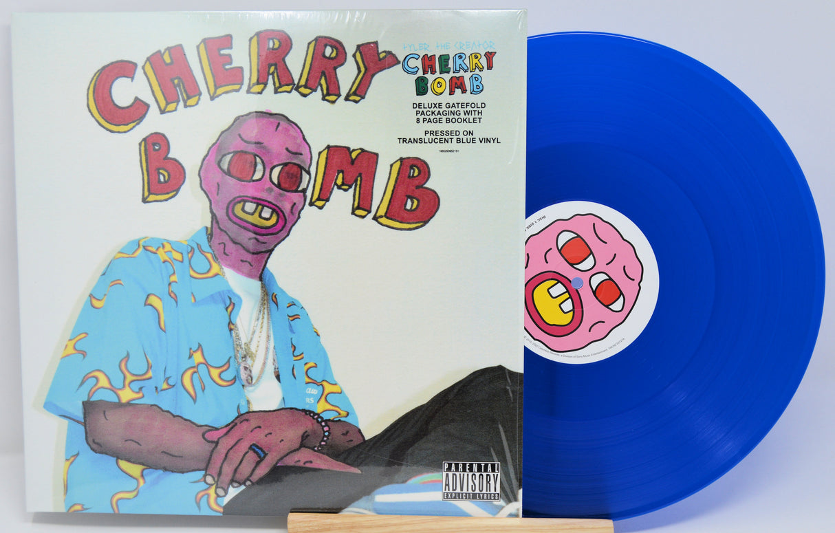 Vinyl record with colorful cover featuring a character and 'Cherry Bomb' text.