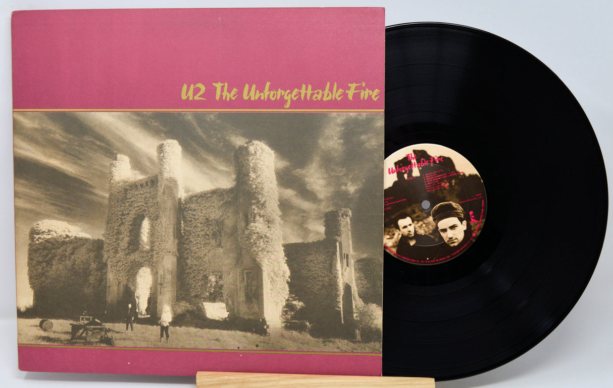 Vinyl record with cover featuring a摧毁ed building and 'U2 The Unforgettable Fire' text