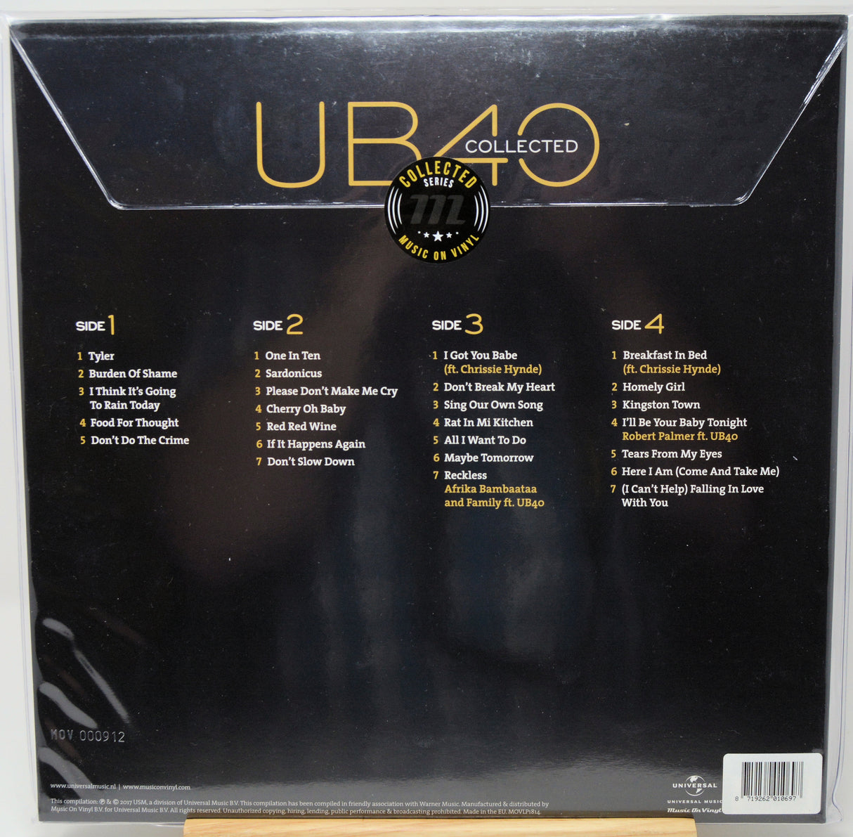 The back cover of a UB40 'Collected' vinyl record package, featuring the album title in large gold letters, track listings for Side 1 through Side 4, and a central circular 'Collector's Edition of CD 1-2' badge on a black background.
