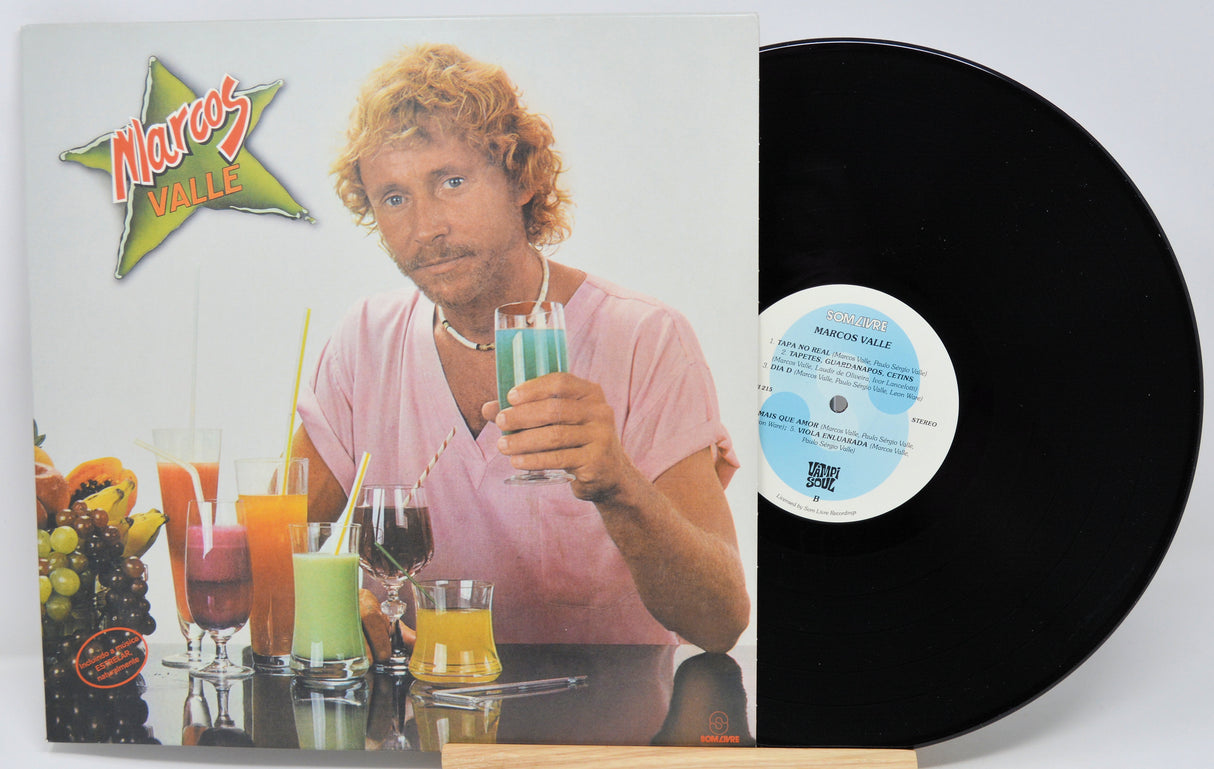 Vinyl record with cover featuring a person holding drinks and colorful drinks on a table.