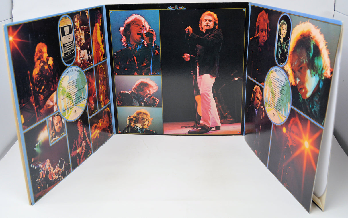 Open book with images of a person on stage and various other images on a white background
