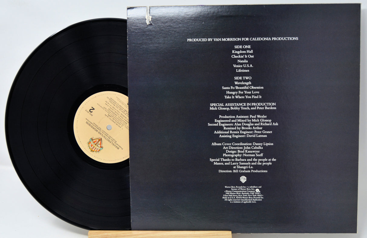 Vinyl record with cover displaying production credits on a white background