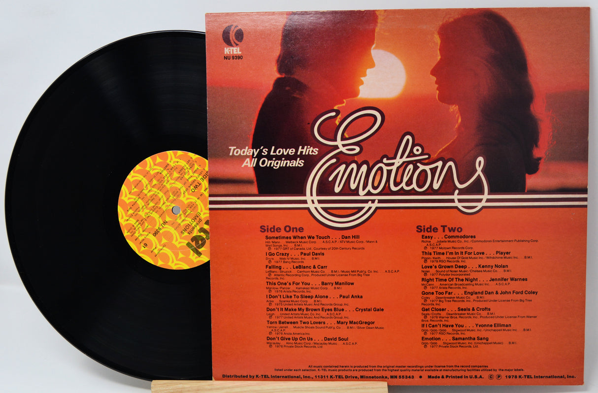 Vinyl record with orange cover featuring a silhouette of a couple and text 'Emotions'.