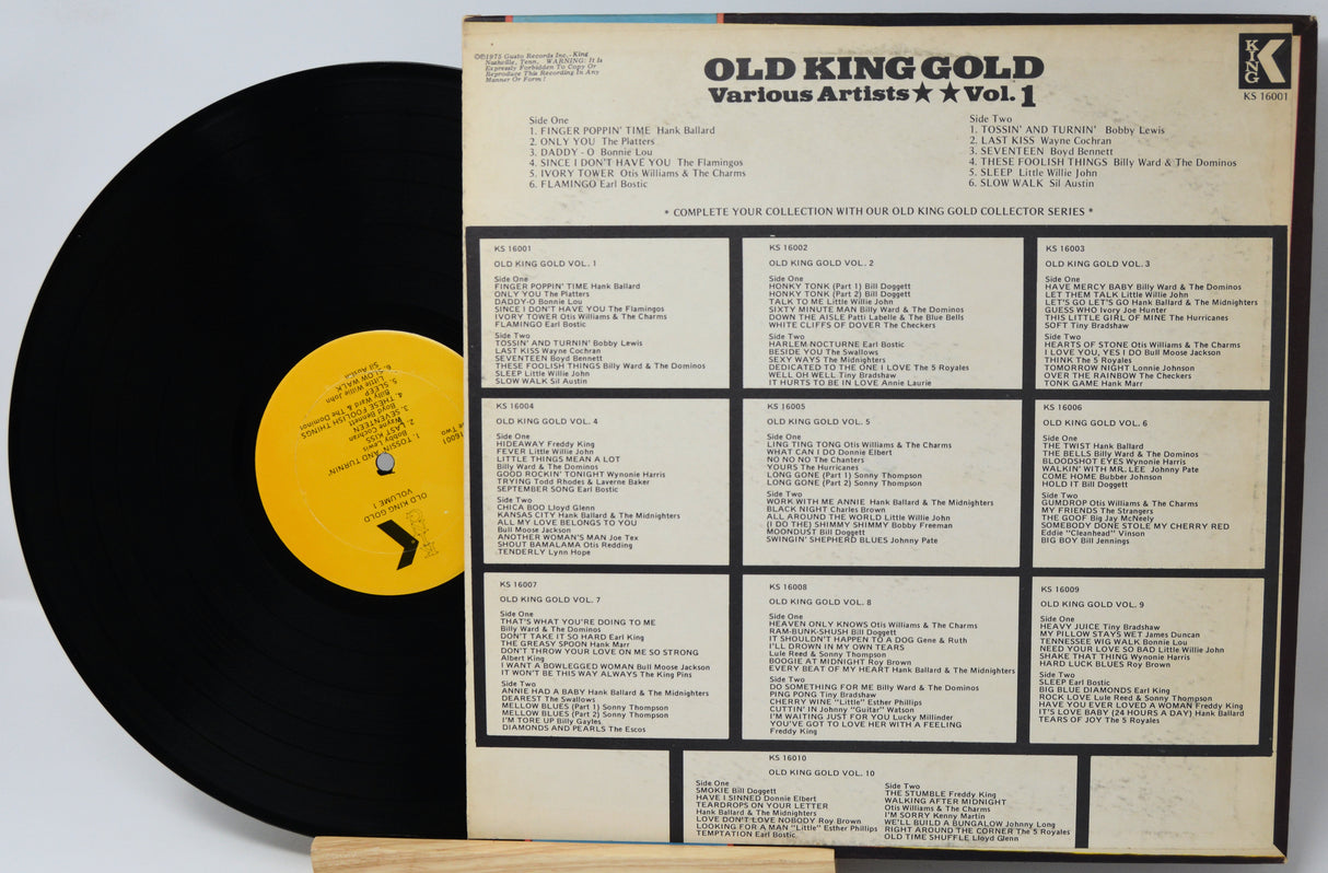 Vinyl record with yellow label and record cover displaying track listings on a white background