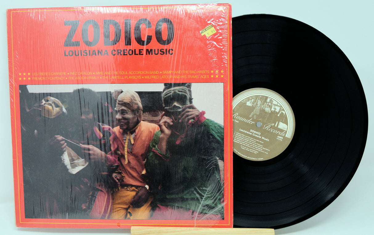 Vinyl record with red cover featuring two people and 'Zodico Louisiana Creole Music' text.
