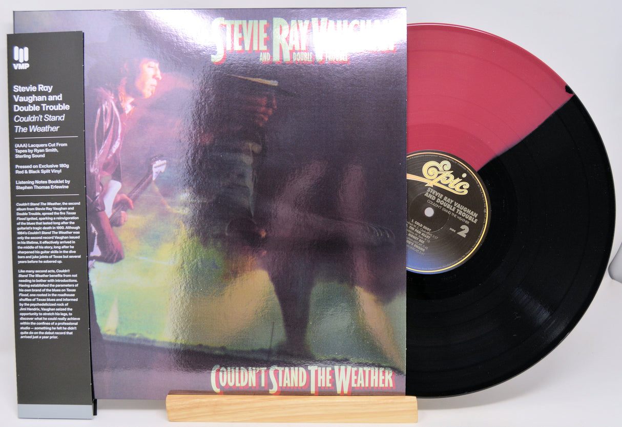 Vinyl record with cover featuring a musician and text, on a white background