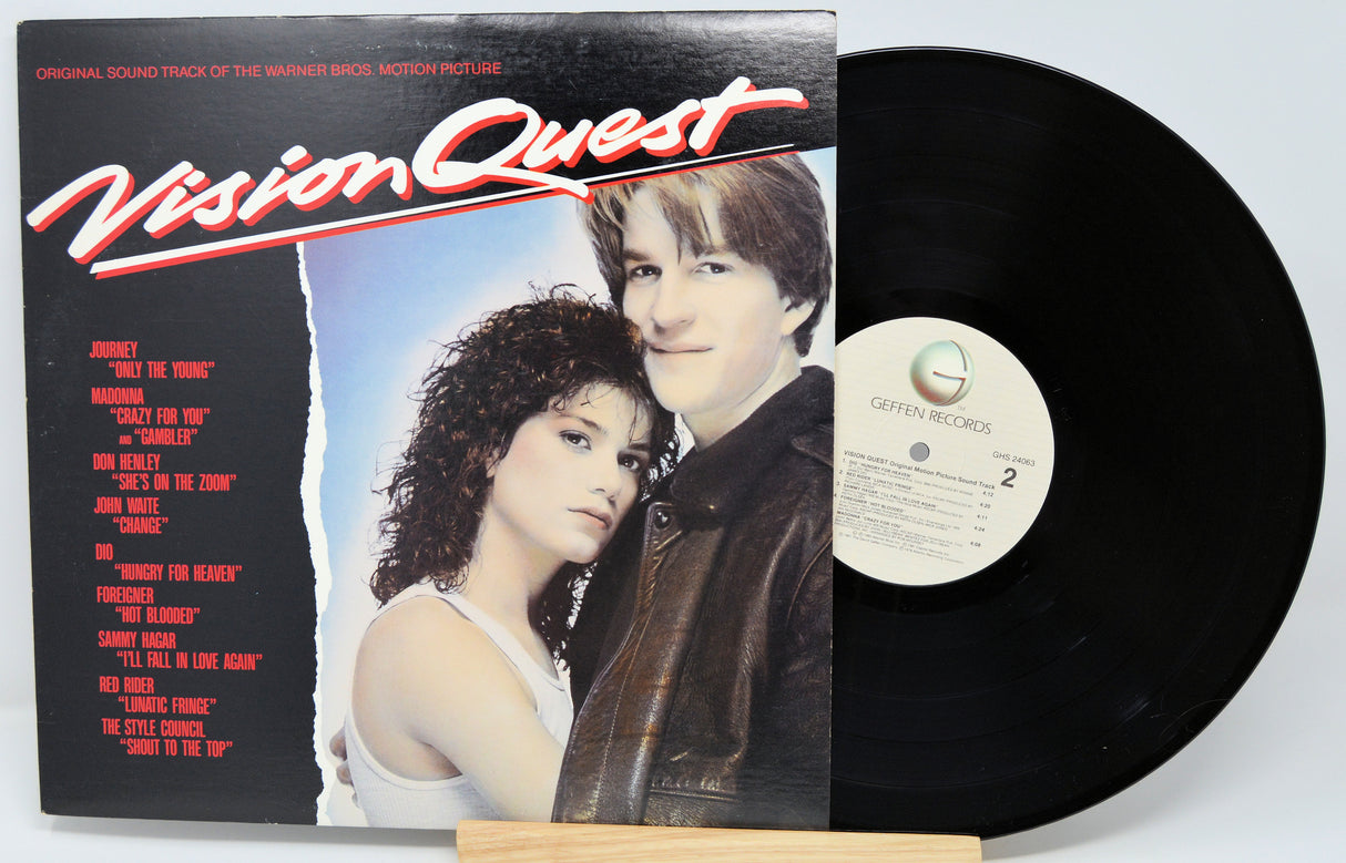 Vinyl record with cover featuring two people and 'Vision Quest' text on a white background