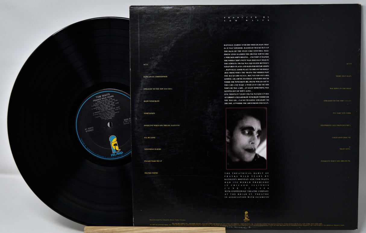 Vinyl record with cover featuring a black and white portrait and text on a gray background