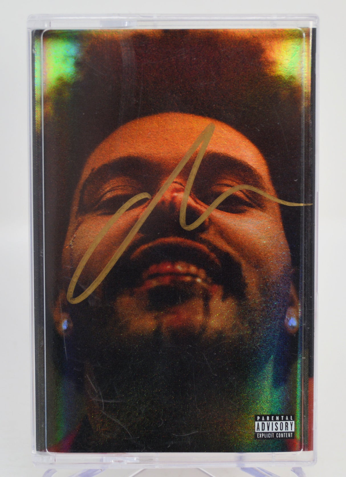 The Weeknd, After Hours Cassette tape with a colorful design featuring a face and a signature, on a white background. Autographed
