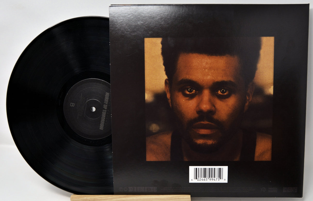 Vinyl record with cover featuring a portrait of a person on a white background