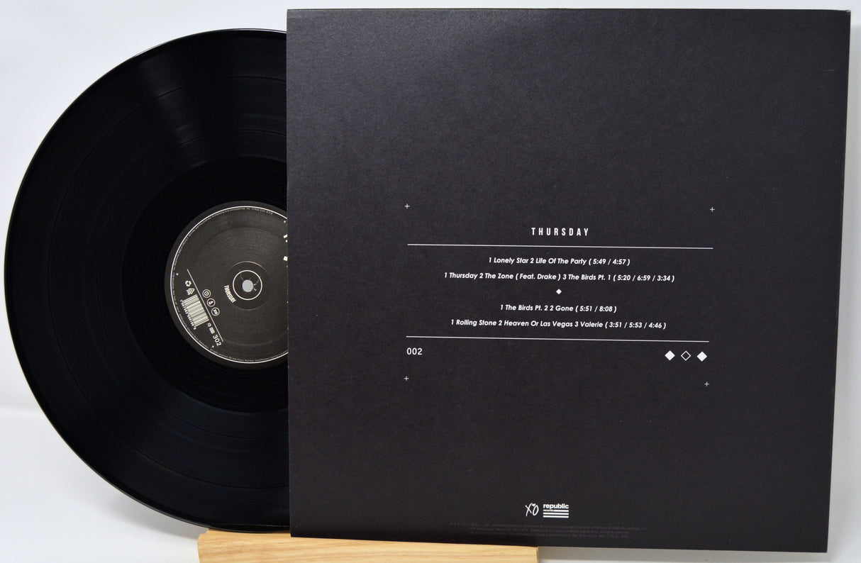 Black vinyl record with a matching black sleeve on a white background