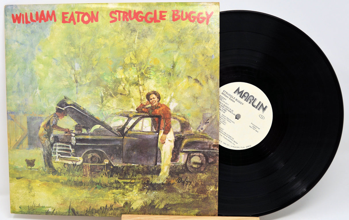 Front cover art of William Eaton's Struggle Buggy vinyl LP showing two men with a vintage car and bold title text