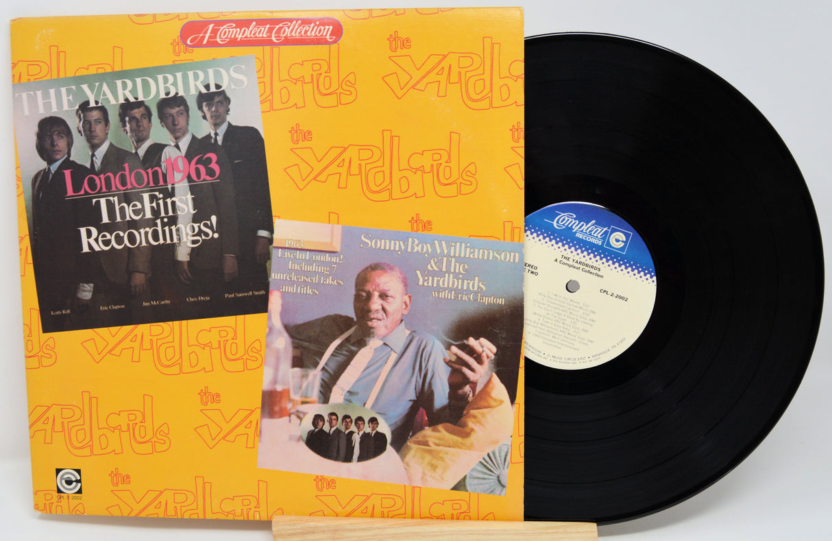 Vinyl record with yellow front cover featuring 'The Yardbirds - A Compleat Collection' and a black record on a white background