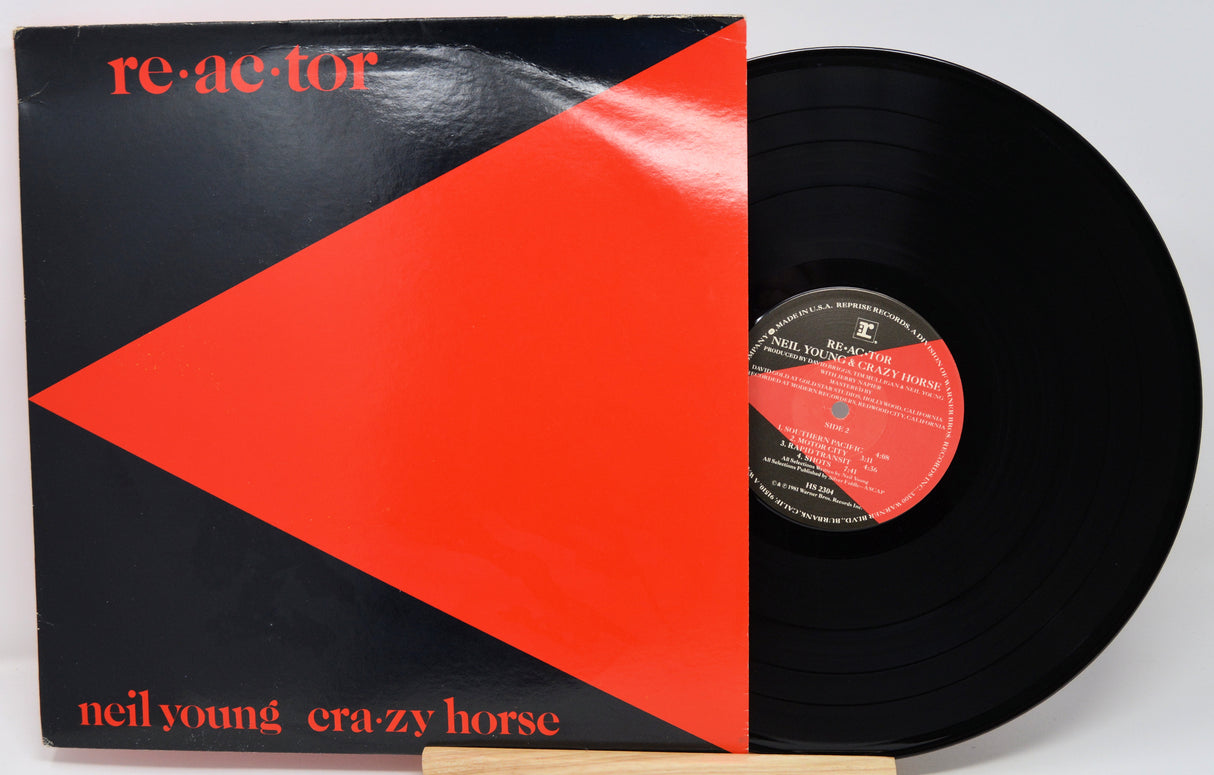 Vinyl record with a red and black cover featuring 'neil young crazy horse' and 'reactor'.