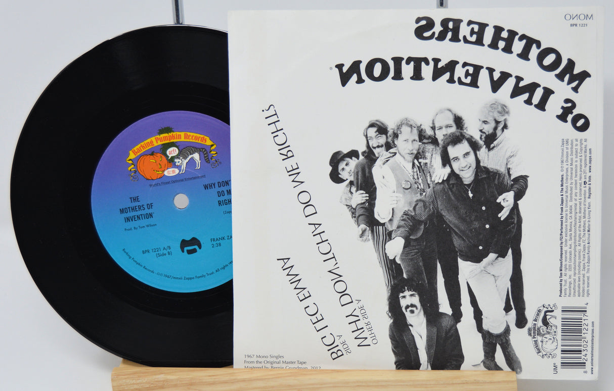 Vinyl record with a colorful label and a music album cover featuring a group of people.