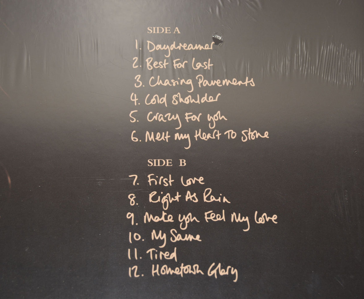 Album cover for 'Adele 19' with a close-up of a person's face and the album title.