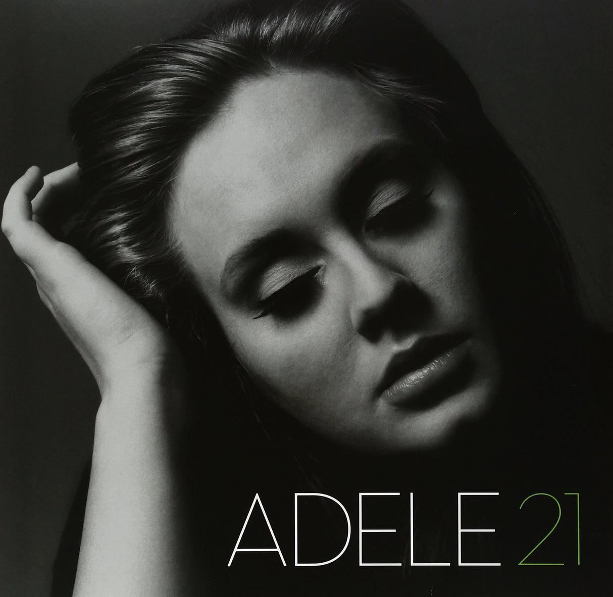 Black and white album cover of Adele with the title '21' in green text.