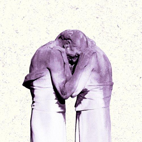 A purple vinyl record of Antlers - Familiars with a sculptural representation of two human figures in a similar purple hue.