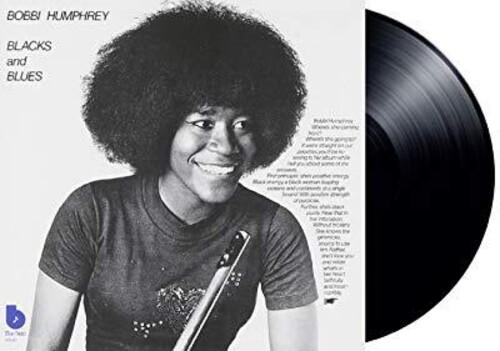 Vinyl record with a person on the cover and text about 'Blacks and Blues'.