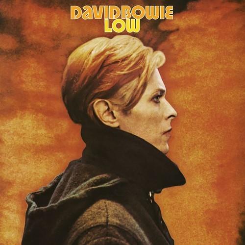 The cover image shows the late David Bowie with a serious expression, wearing a dark outfit against a warm, orange-toned background that suggests a fiery or volcanic setting. The album title 'Low' by David Bowie is prominently displayed at the top in a stylized font, and the RCA Records logo is visible in the upper left corner.