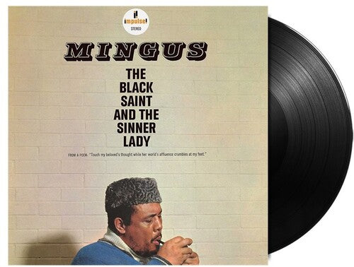 Vinyl record with cover featuring a man and text 'Mingus: The Black Saint and the Sinner Lady' on a beige background.