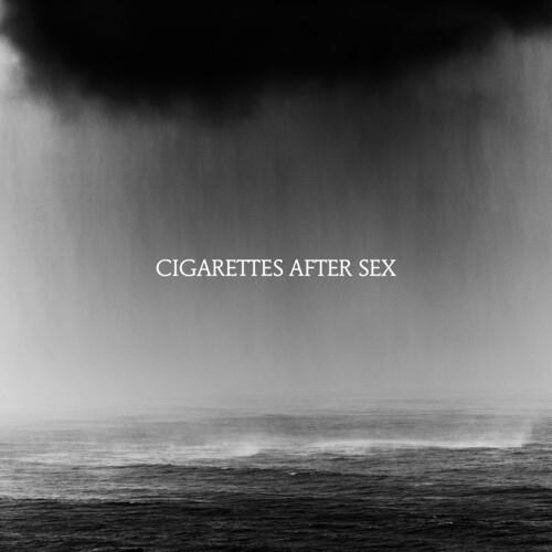 Black and white album cover featuring a misty sea landscape with the band's name 'Cigarettes After Sex' displayed prominently.