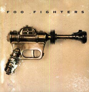 The image features the album cover of "Foo Fighters - Foo Fighters," the debut studio album by the American alternative rock band Foo Fighters. The cover art displays a vintage-style photograph of a ray gun, emphasizing a retro and eclectic aesthetic.