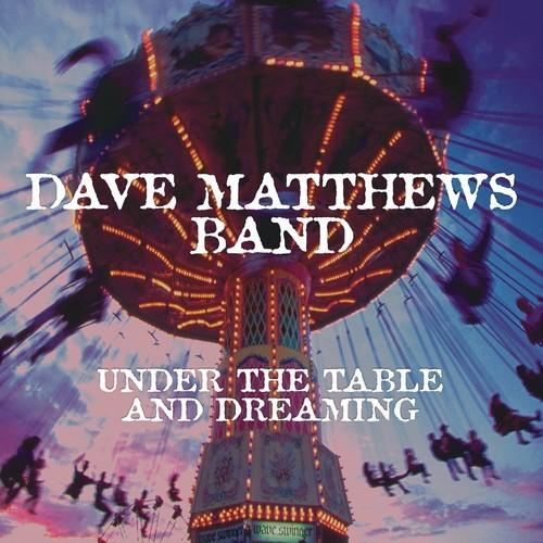 Album cover for Dave Matthews Band's 'Under The Table And Dreaming' featuring a colorful amusement park ride at night.