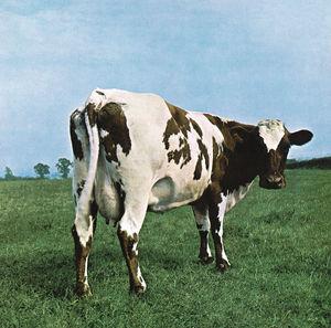 The image depicts the cover art for the vinyl LP of Pink Floyd's album "Atom Heart Mother." It features a minimalist design with a simple, serene depiction of a cow in a field of green grass.