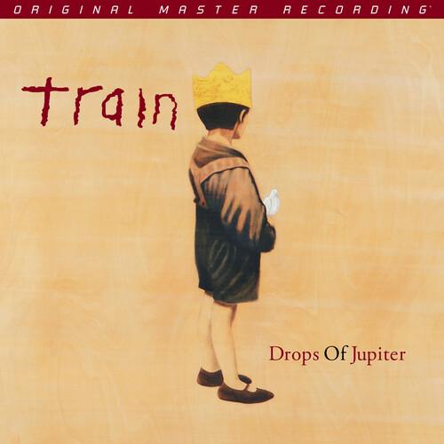 Album cover for 'Drops Of Jupiter' by Train with a person in a coat and crown on a beige background.