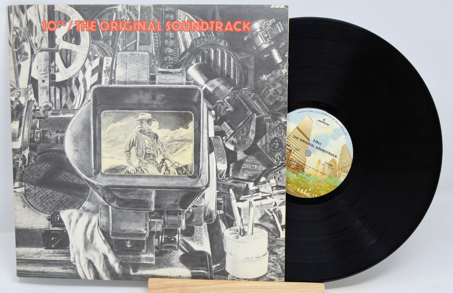 A vinyl record of 10CC - The Original Soundtrack album placed on a record sleeve with a graphic design.
