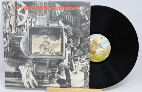 A vinyl record of 10CC - The Original Soundtrack album placed on a record sleeve with a graphic design.