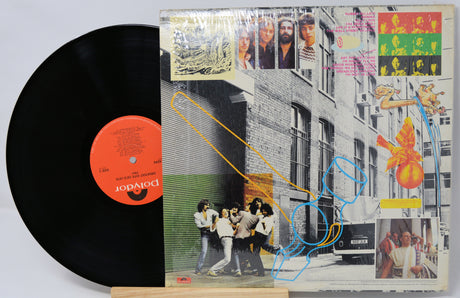 Vinyl record with a colorful cover featuring people and abstract designs.