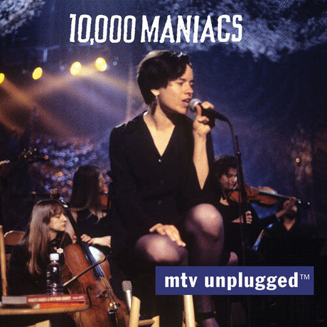 Musician performing on stage with '10,000 Maniacs' and 'MTV Unplugged' logos.