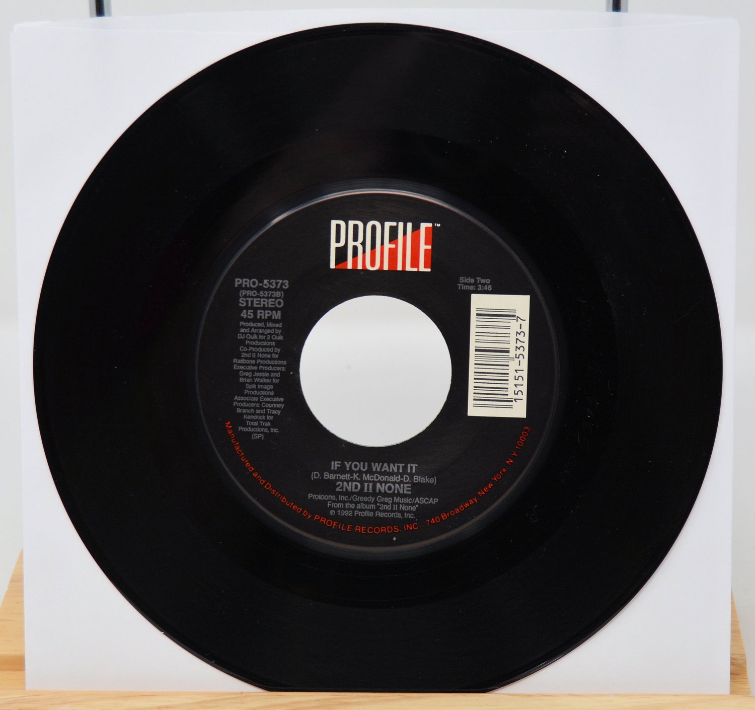 Black vinyl record with 'PROFILE' label on a white background